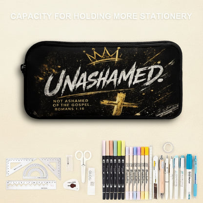 A black zippered pencil case with a distressed gold and white 'UNASHAMED' graphic, shown with stationery items including markers, pens, scissors, rulers, and tape on a split light blue and white background. Text at the top reads 'CAPACITY FOR HOLDING MORE STATIONERY'.