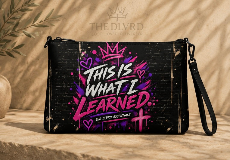 Black crossbody bag with purple slogan graphic and adjustable crossbody strap