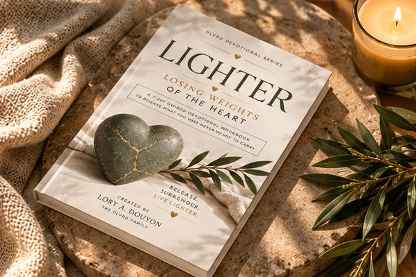 Devotional workbook flat on cloth with green heart cover and 'Lighter' title