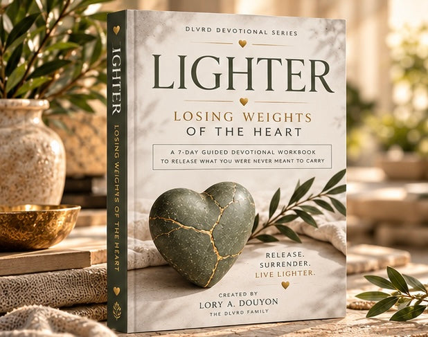 Devotional workbook cover on tabletop with dark green heart and leafy accents