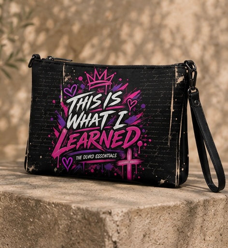 Black crossbody bag with purple graphic print, double zippers, side wrist strap