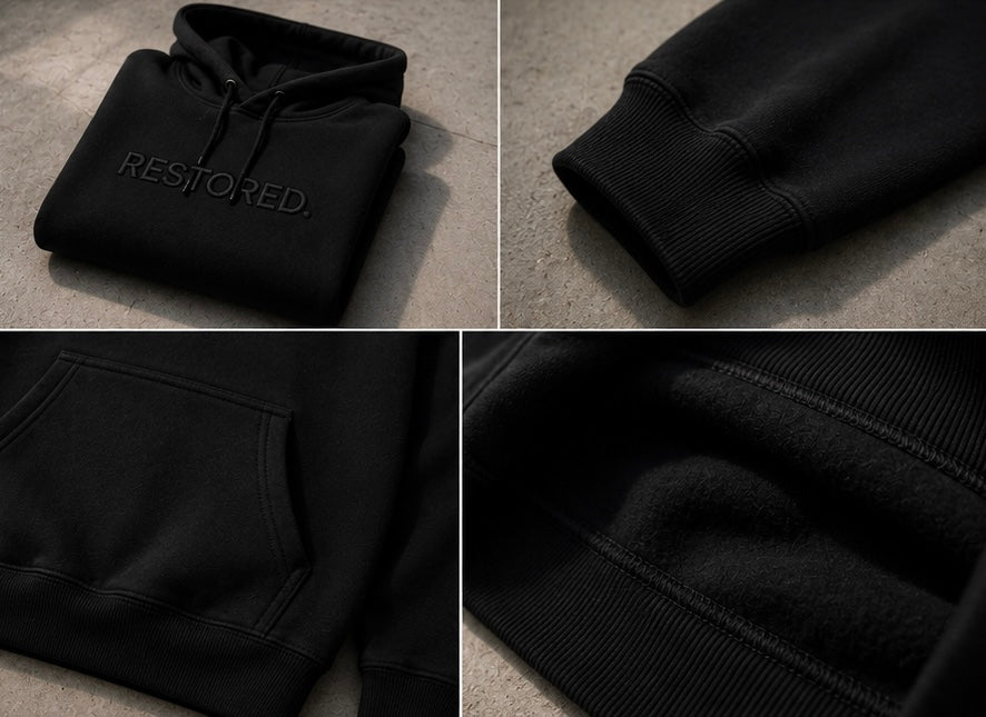 A black pullover hoodie shown in a four-panel collage with close-up views of the front pocket, ribbed cuff, hood, and interior lining. The word 'RESTORED.