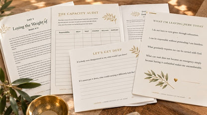 Devotional workbook open beside loose pages with day headings and guided questions