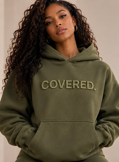 Army green hoodie with COVERED. logo, front pocket and drawstring hood