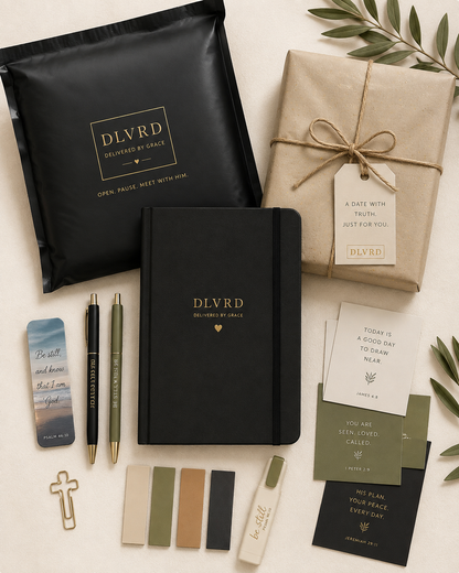 Devotional journal set with DLVRD notebooks, pens, gift wraps, note cards, and cross charm.