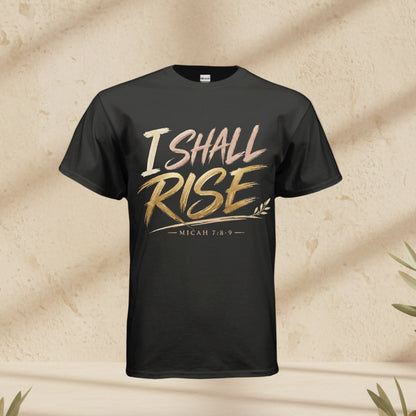 A black short-sleeve t-shirt with a graphic on the chest reading 'I SHALL RISE' in a metallic gold and rose gold gradient, with 'MICAH 7:8-9' printed below, shown against a plain white background.