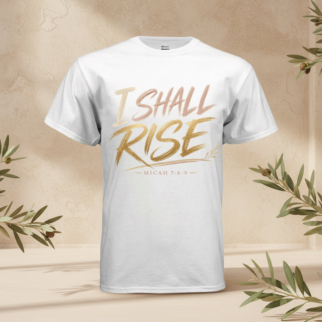 A white short-sleeve crewneck t-shirt featuring a metallic gold and rose gold graphic print on the front that reads 'I SHALL RISE' with 'MICAH 7:8-9' underneath.