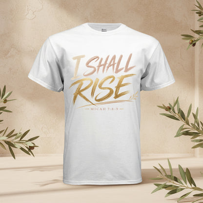 A white short-sleeve crewneck t-shirt featuring a metallic gold and rose gold graphic print on the front that reads 'I SHALL RISE' with 'MICAH 7:8-9' underneath.