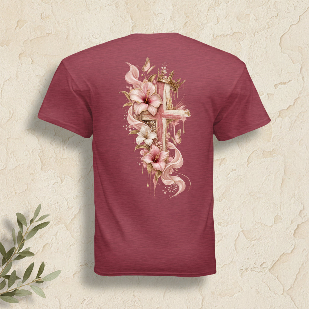 A heathered maroon short-sleeve t-shirt shown from the back, featuring a large graphic print of a gold cross decorated with pink and white lilies and gold leaf details.