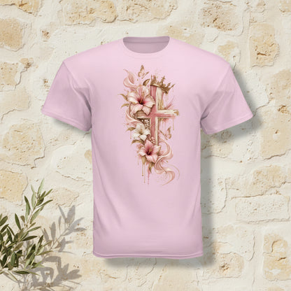 A light pink short-sleeve t-shirt shown from the back, featuring a large graphic print of a cross adorned with pink and white lilies, gold accents, and a crown.