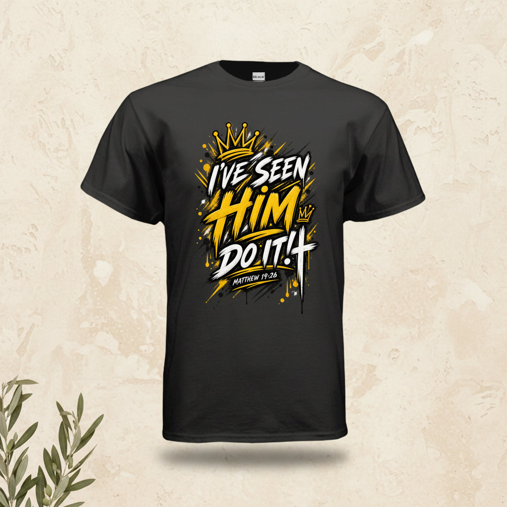 A black short-sleeve t-shirt with a bold graphic on the chest reading 'I'VE SEEN HIM DO IT! MATTHEW 12:30' in white and yellow with a gold crown illustration, shown on a plain white background.
