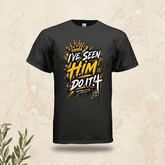 A black short-sleeve t-shirt with a bold graphic on the chest reading 'I'VE SEEN HIM DO IT! MATTHEW 12:30' in white and yellow with a gold crown illustration, shown on a plain white background.